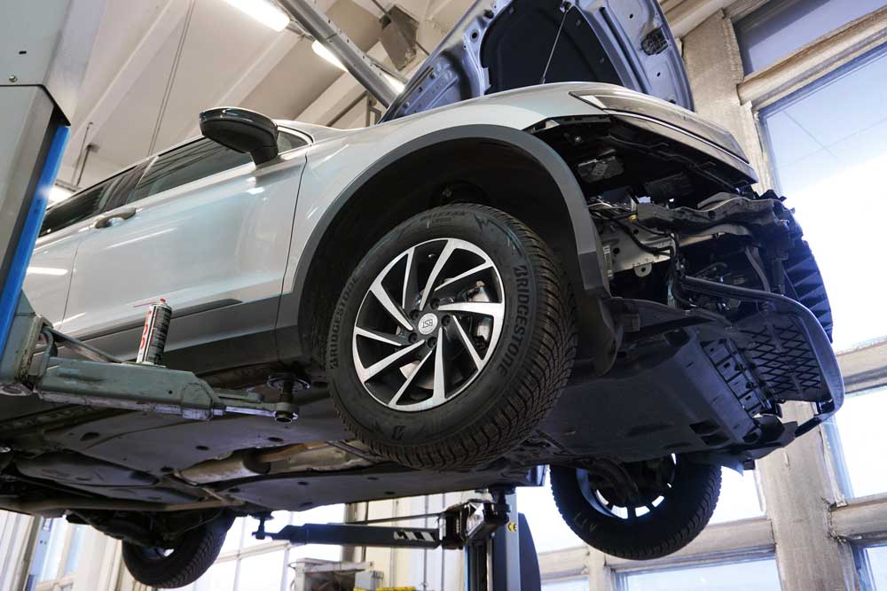 Vehicle raised on a lift for auto repair in Racine, WI